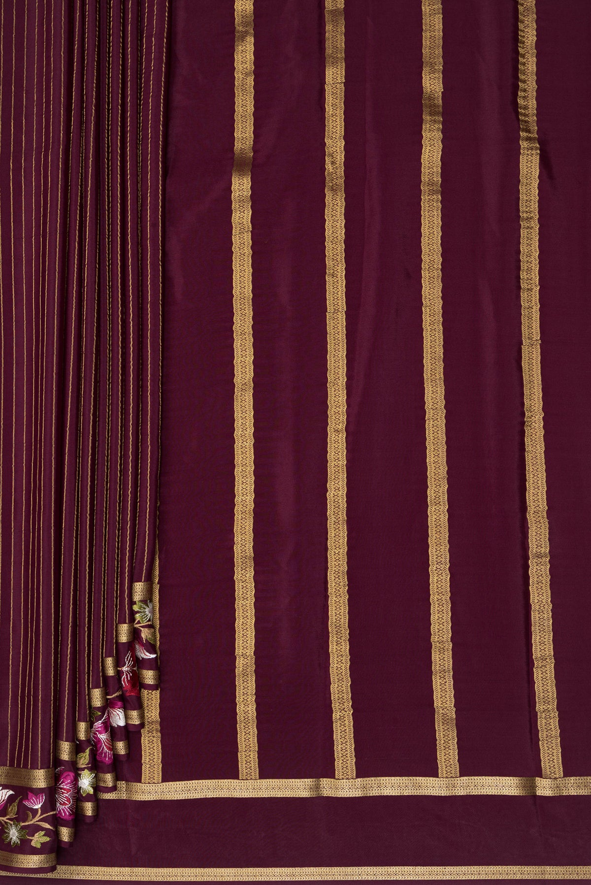 Pleats and pallu of Coffee Brown Mysore Crepe Saree with Stripes on the body and Embroidered Border. 