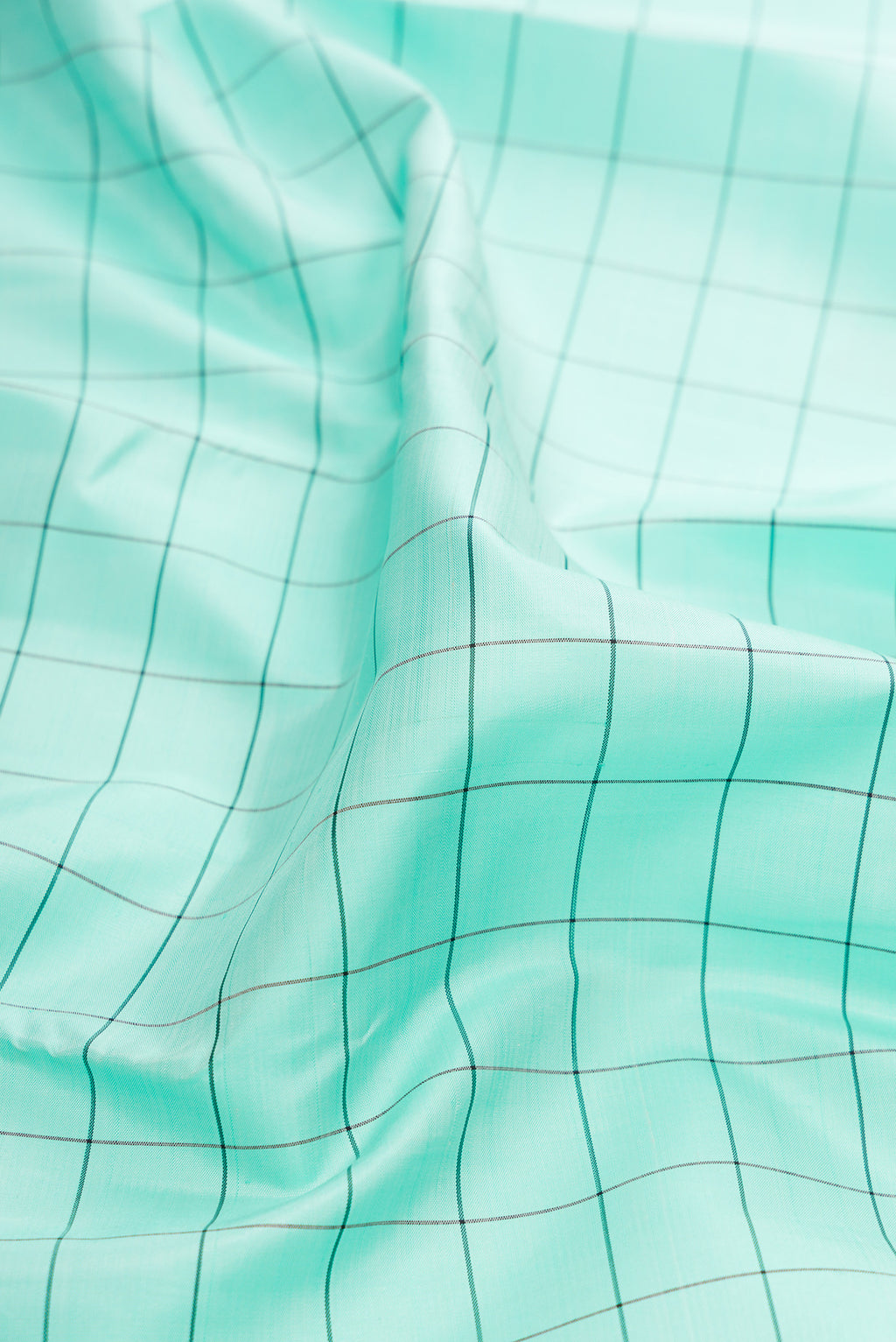 Close up of Pure Silk Sea Green Kanjivaram Saree with Checked design on the body and Ganga Jamuna Border.  displaying folds