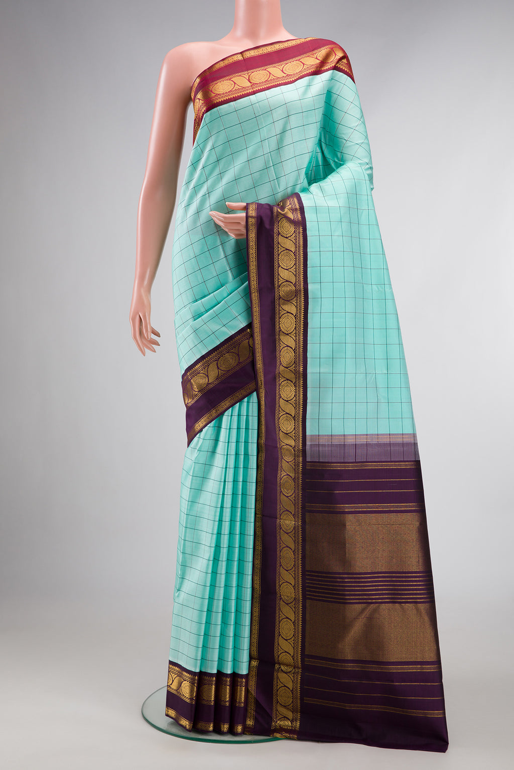 Pure Silk Sea Green Kanjivaram Saree with Checked design on the body and Ganga Jamuna Border.  displayed on a mannequin