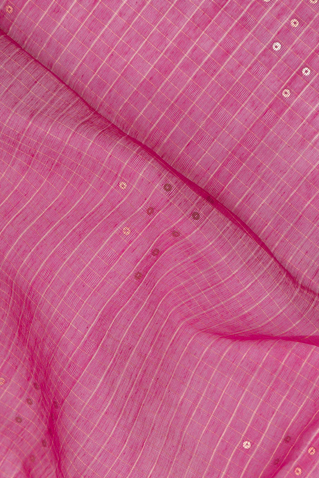 Close up of Pink Tussar Saree with Checked design on the body and Zari Border.  displaying folds