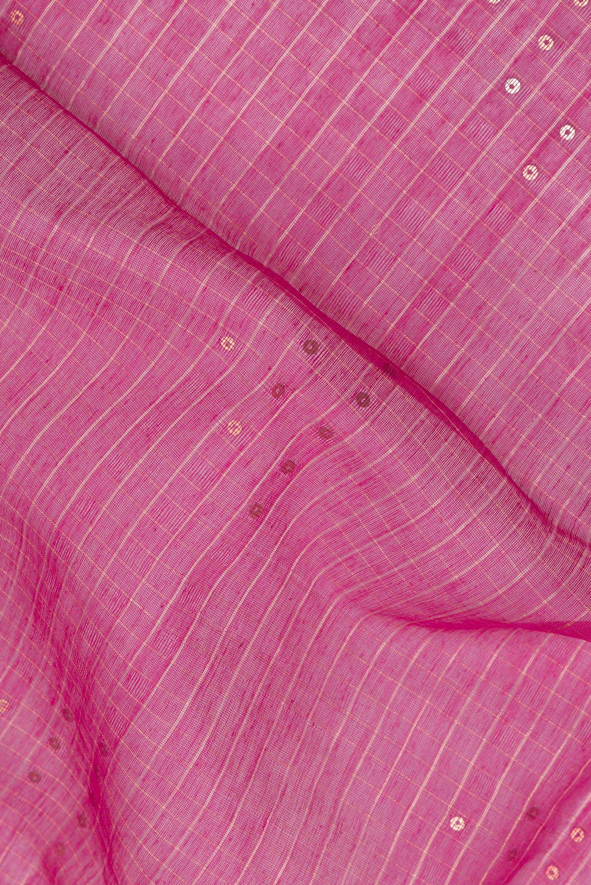 Close up of Pink Tussar Saree with Checked design on the body and Zari Border.  displaying folds