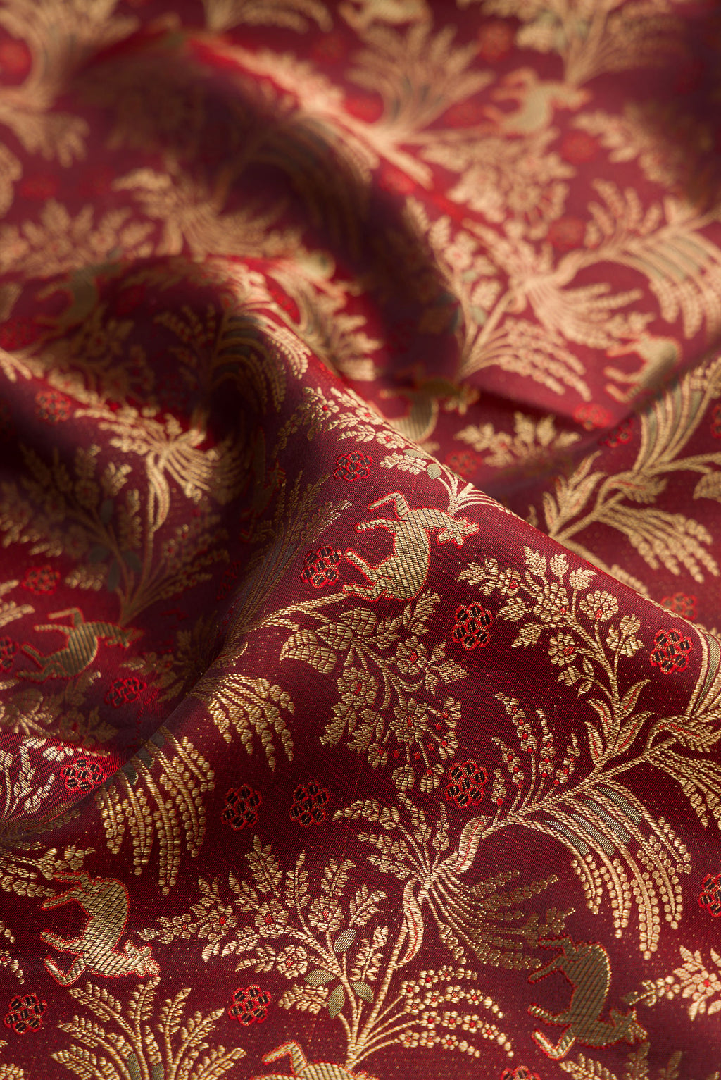 Close up of Maroon Kanjivaram Silk Saree with Zari Brocade on the body and Zari Border.  displaying folds
