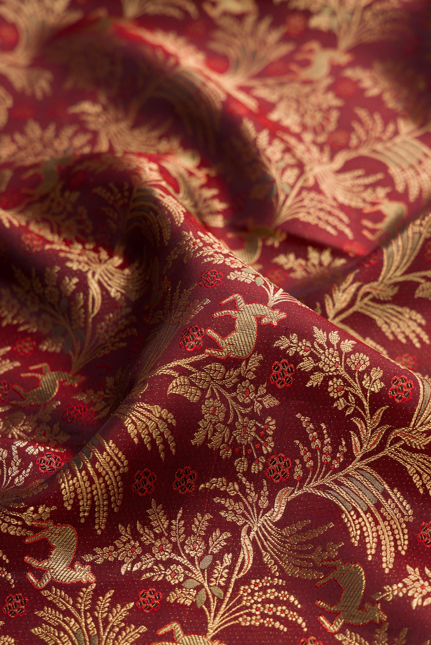Close up of Maroon Kanjivaram Silk Saree with Zari Brocade on the body and Zari Border.  displaying folds