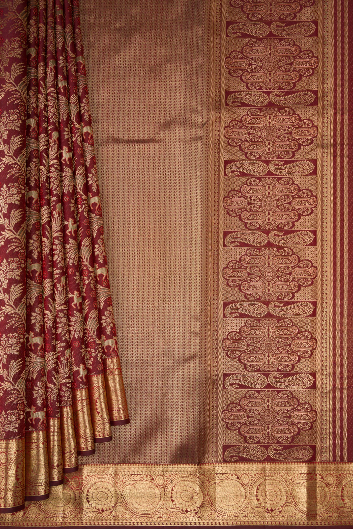Pleats and pallu of Maroon Kanjivaram Silk Saree with Zari Brocade on the body and Zari Border. 