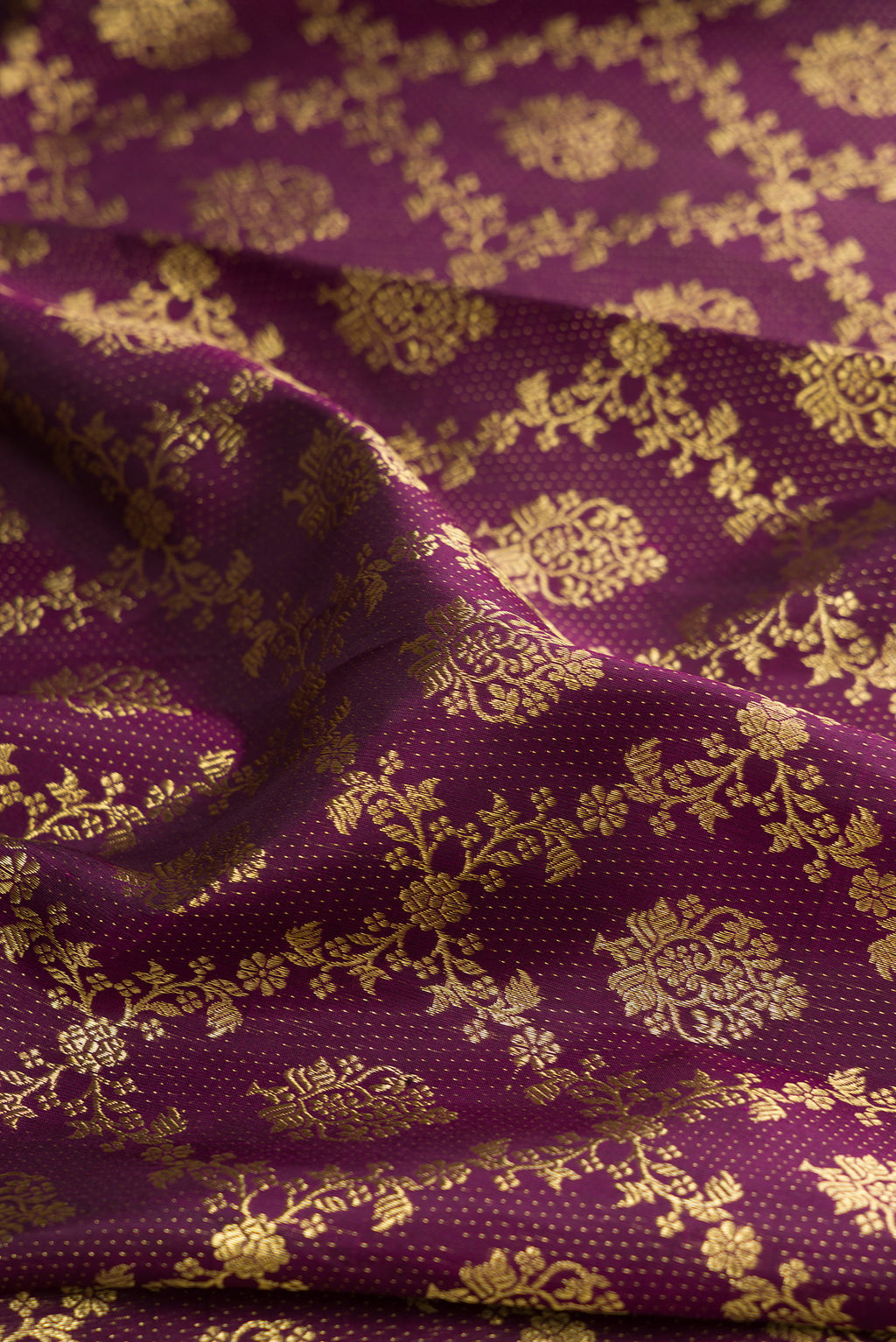 Close up of Burgundy Kanjivaram Silk Saree with Zari Brocade on the body and Zari Border.  displaying folds