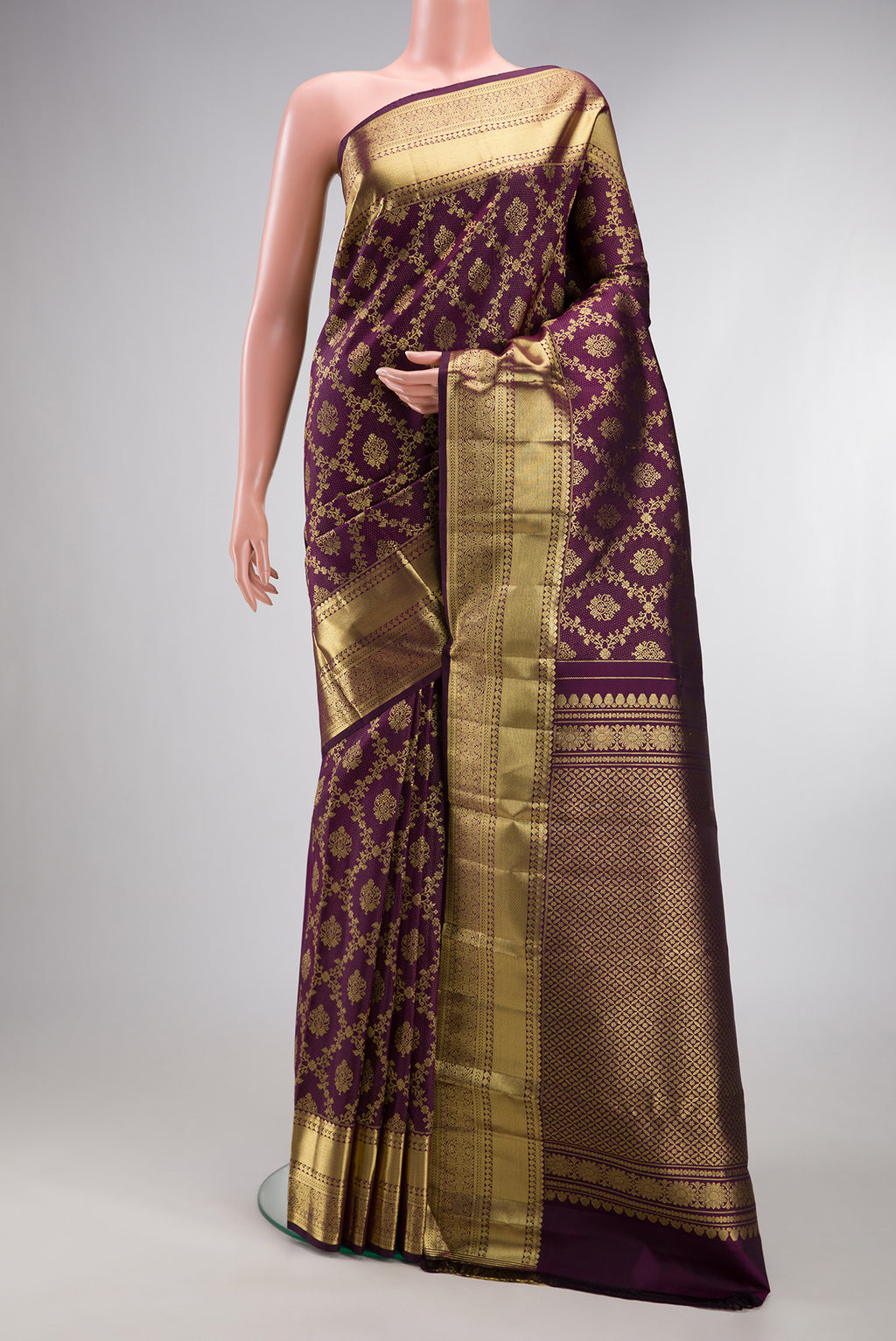 Burgundy Kanjivaram Silk Saree with Zari Brocade on the body and Zari Border.  displayed on a mannequin