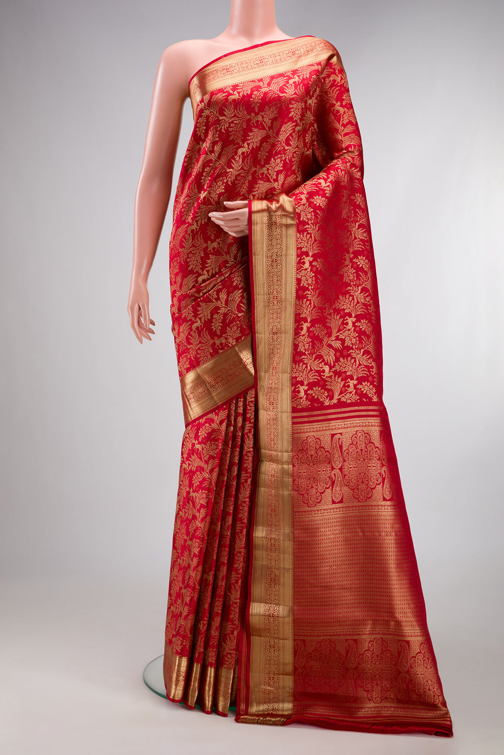 Red Kanjivaram Silk Saree with Zari Brocade on the body and Zari Border.  displayed on a mannequin