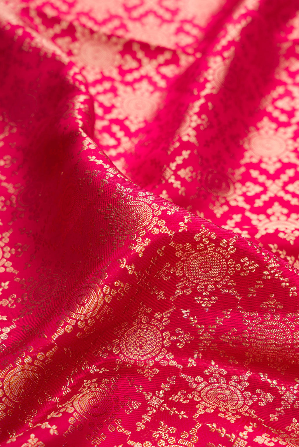 Close up of Pure Silk Dark Pink Kanjivaram Saree with Zari Brocade on the body and Zari Border.  displaying folds