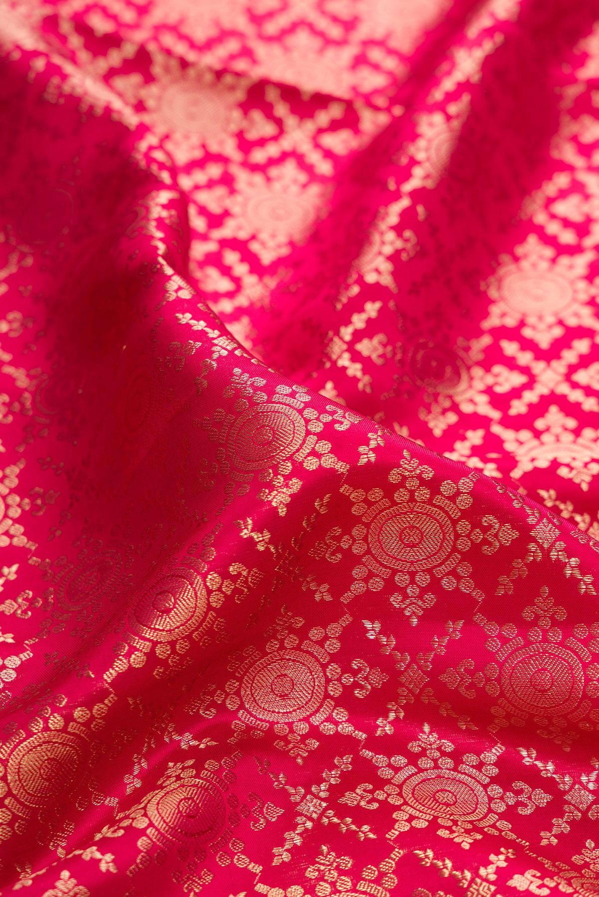 Close up of Pure Silk Dark Pink Kanjivaram Saree with Zari Brocade on the body and Zari Border.  displaying folds