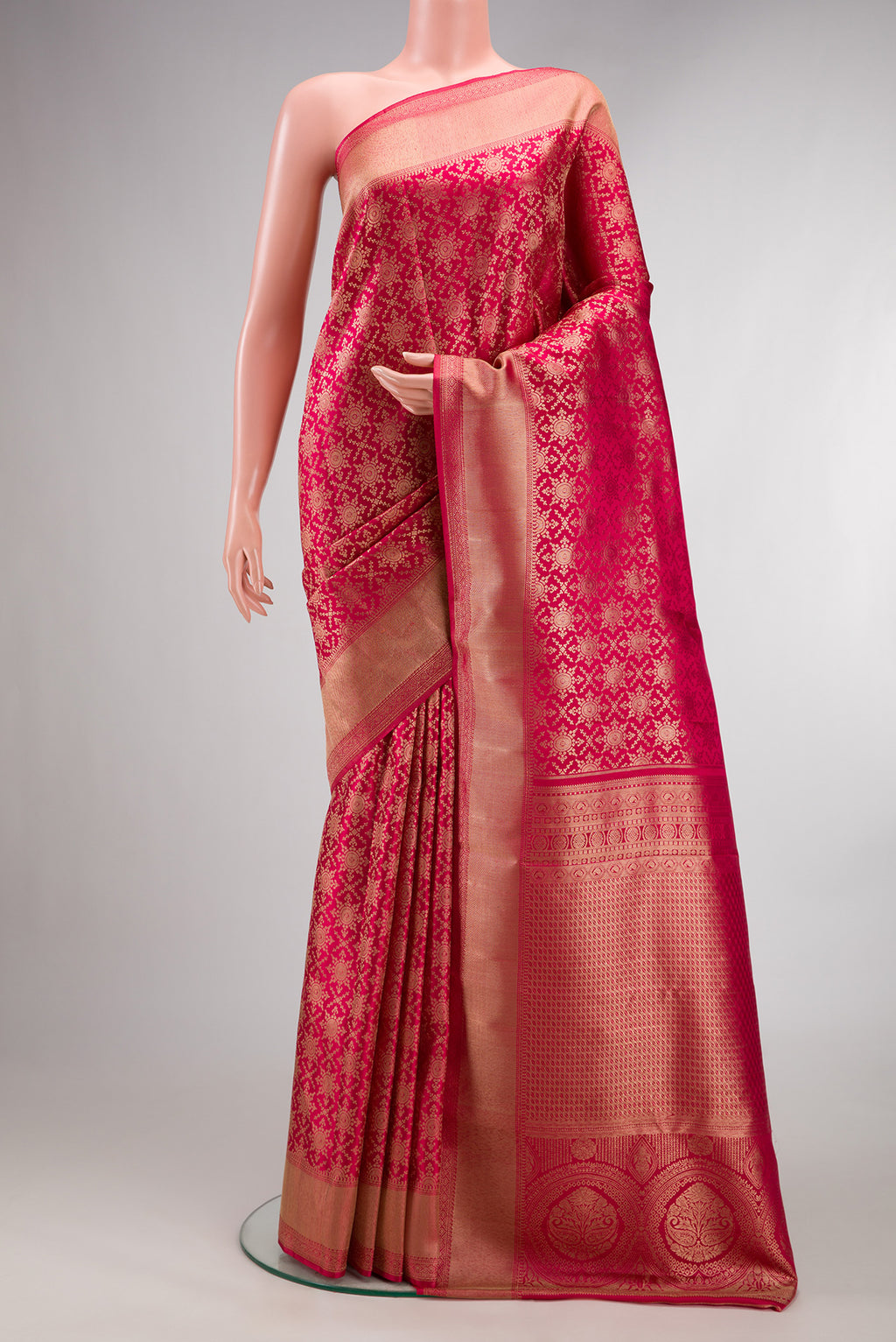 Pure Silk Dark Pink Kanjivaram Saree with Zari Brocade on the body and Zari Border.  displayed on a mannequin