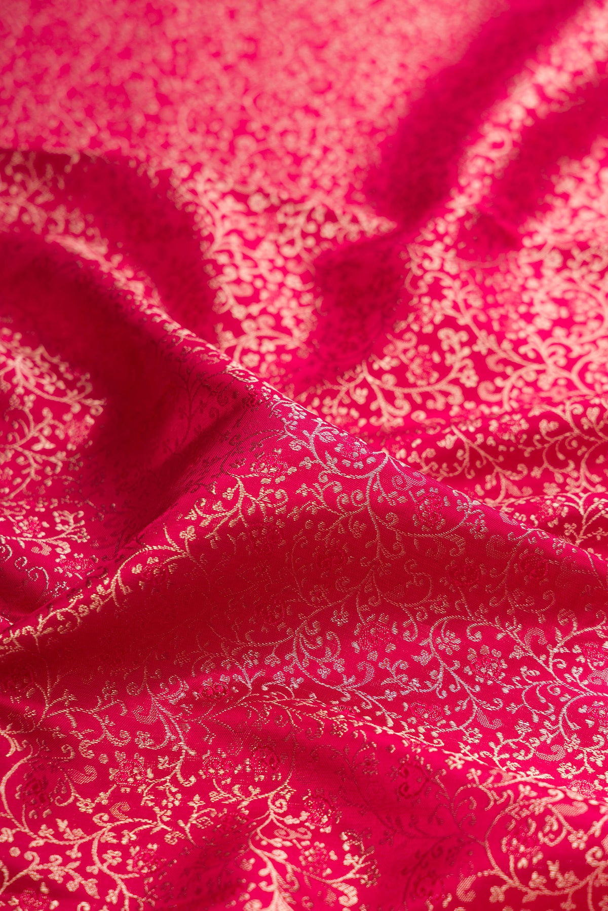 Close up of Dark Pink Kanjivaram Silk Saree with Zari Brocade on the body and Paithani Border.  displaying folds