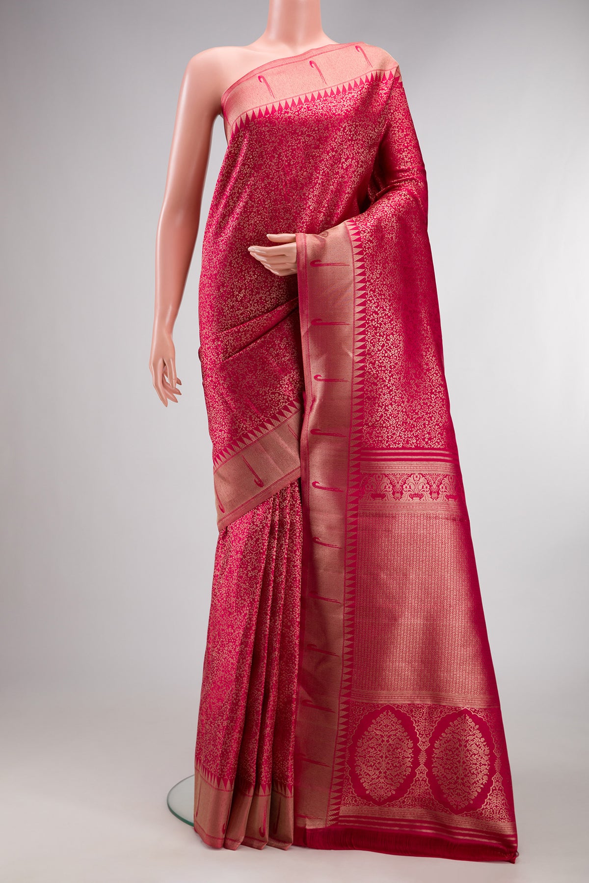 Dark Pink Kanjivaram Silk Saree with Zari Brocade on the body and Paithani Border.  displayed on a mannequin