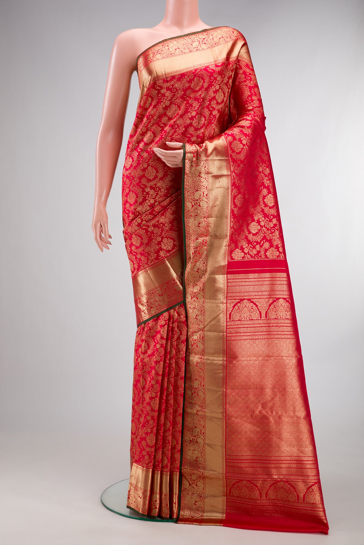 Pure Silk Red Kanjivaram Saree with Zari Brocade on the body and Zari Border.  displayed on a mannequin