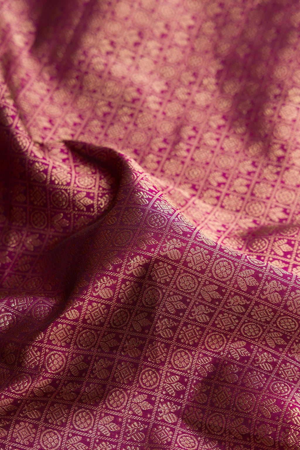 Close up of Pure Silk Magenta Kanjivaram Saree with Zari Brocade on the body and Zari Border.  displaying folds