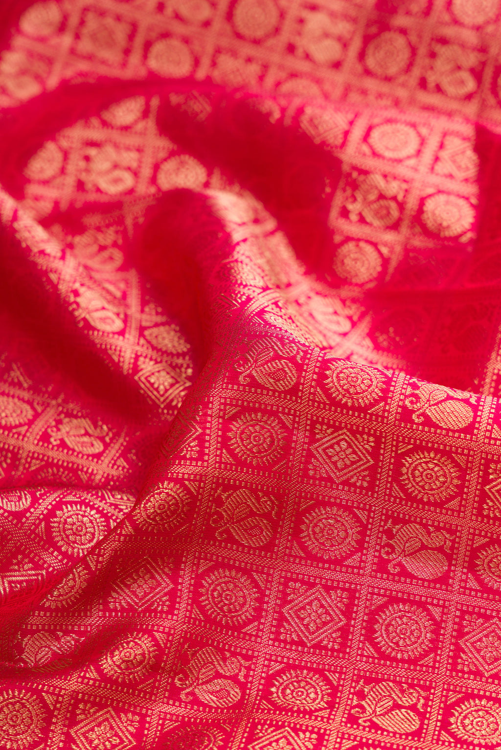 Close up of Dark Pink Kanjivaram Silk Saree with Zari Brocade on the body and Zari Border.  displaying folds