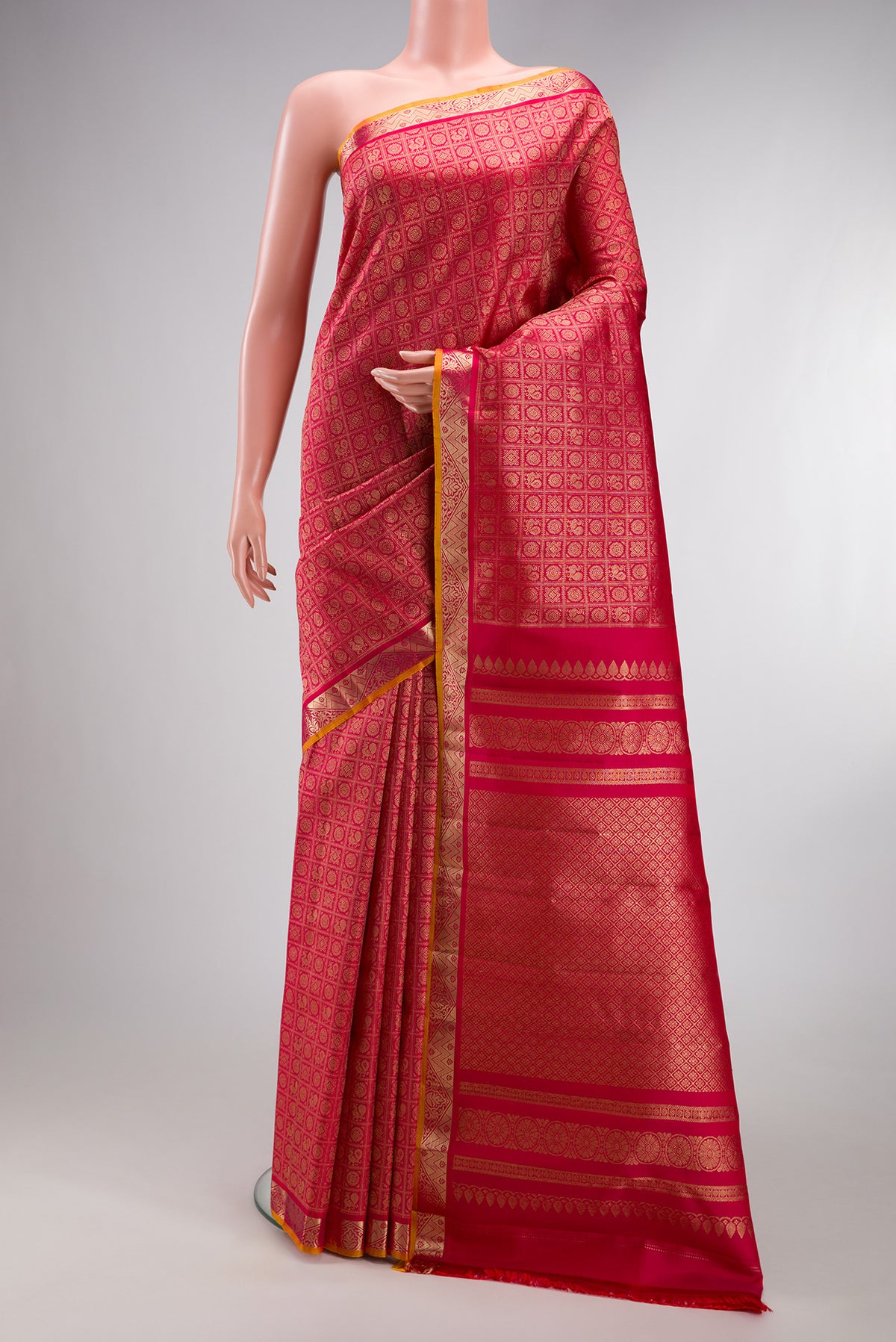 Dark Pink Kanjivaram Silk Saree with Zari Brocade on the body and Zari Border.  displayed on a mannequin
