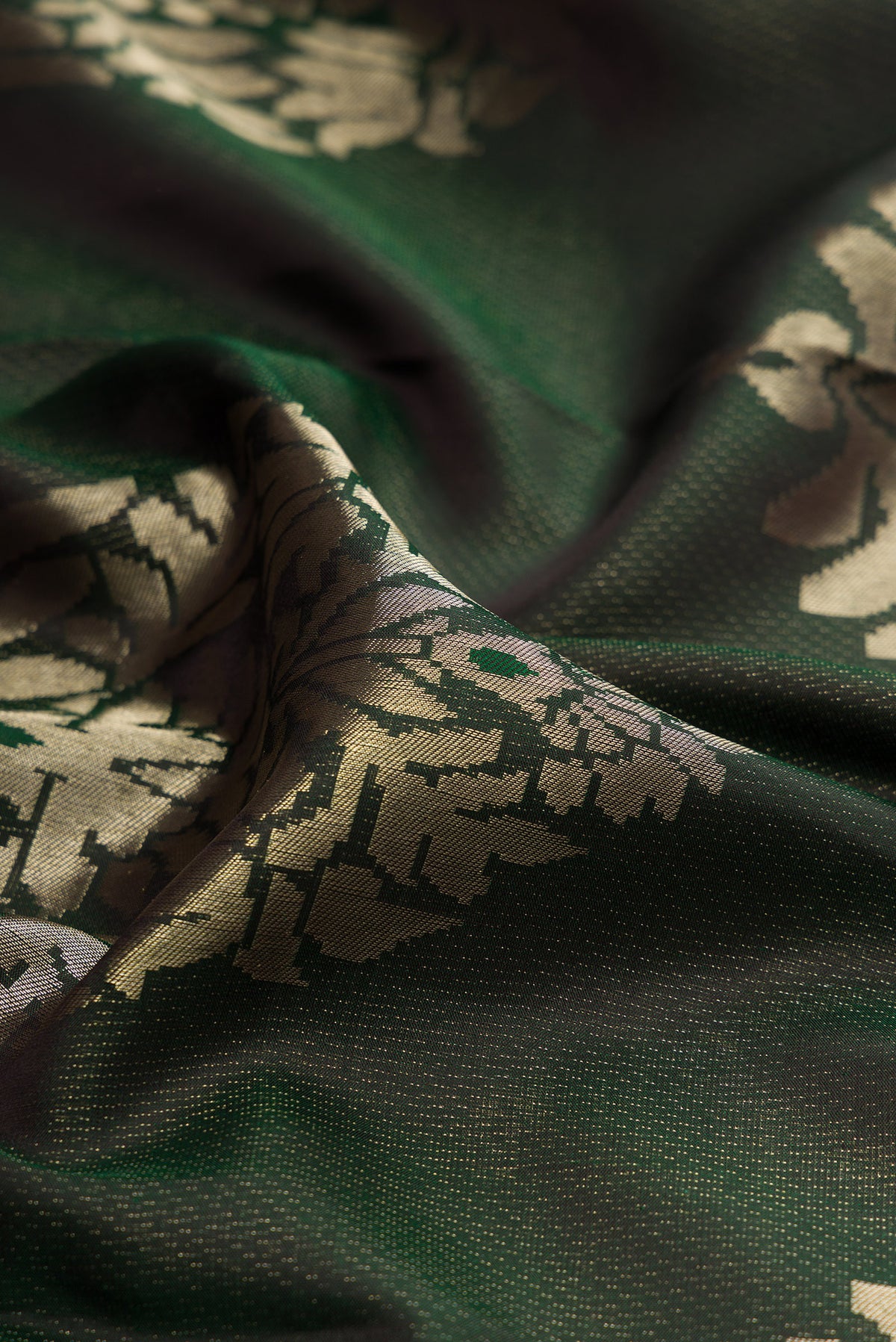 Close up of Bottle Green Kanjivaram Silk Saree with Zari Brocade on the body and Fancy Border.  displaying folds