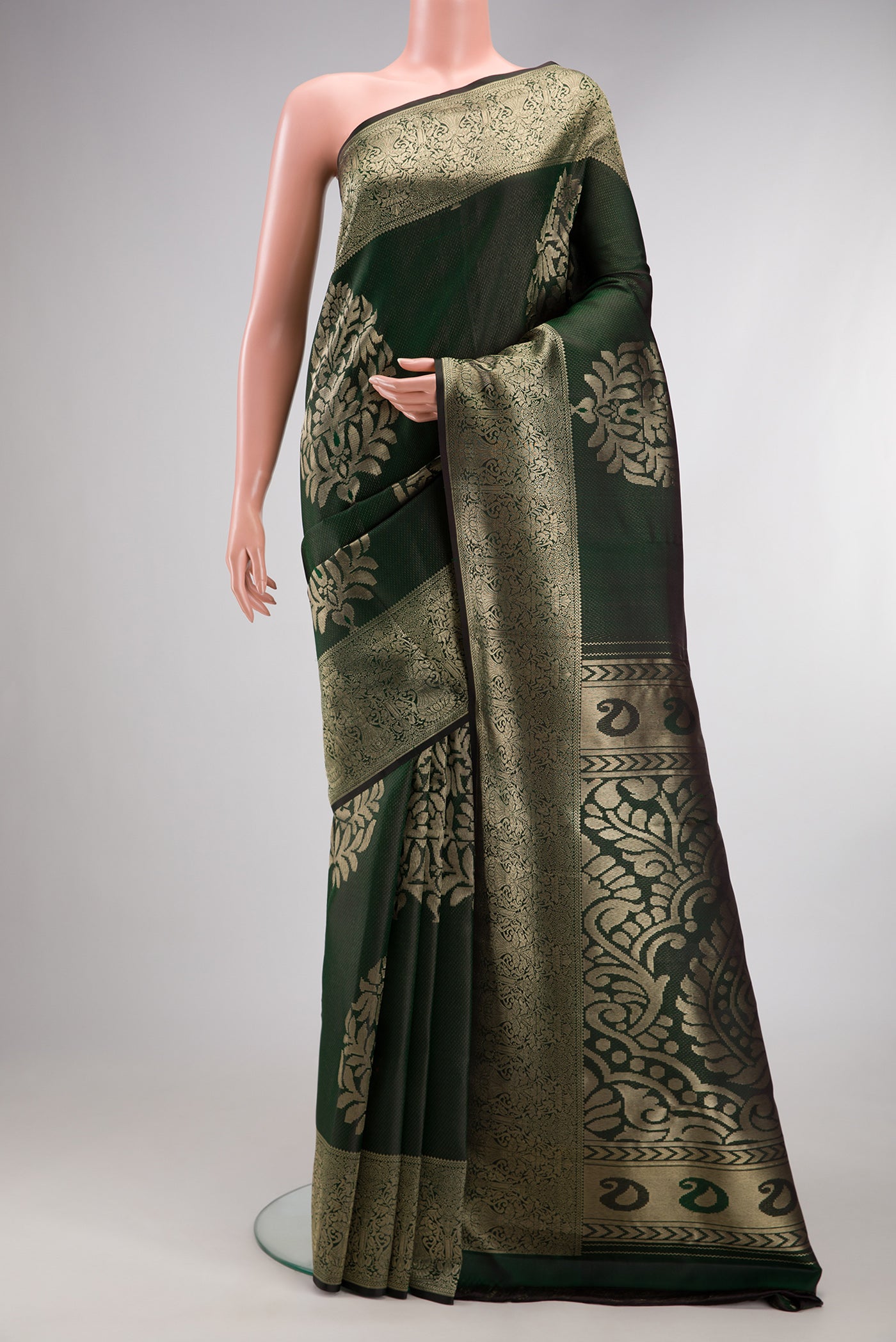 Bottle Green Kanjivaram Silk Saree with Zari Brocade on the body and Fancy Border.  displayed on a mannequin
