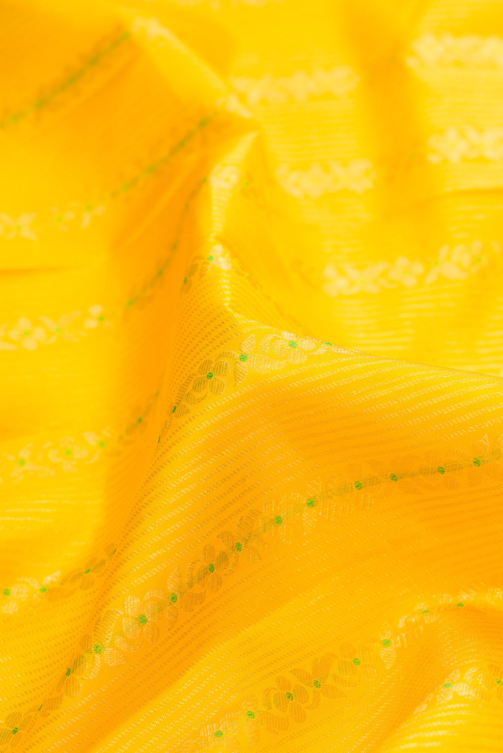 Close up of Pure Silk Yellow Kanjivaram Saree with Stripes on the body and Zari Border.  displaying folds