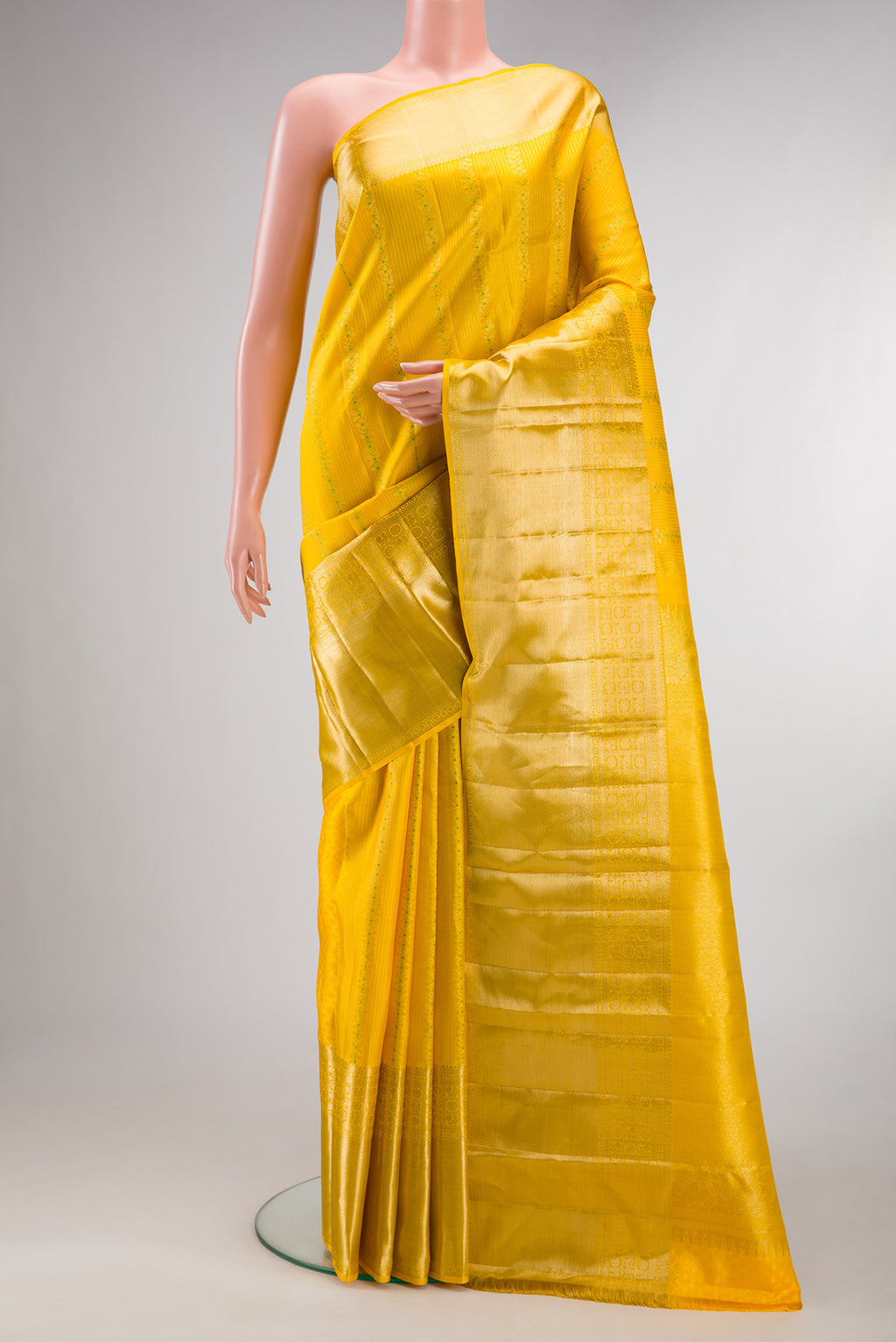 Pure Silk Yellow Kanjivaram Saree with Stripes on the body and Zari Border.  displayed on a mannequin