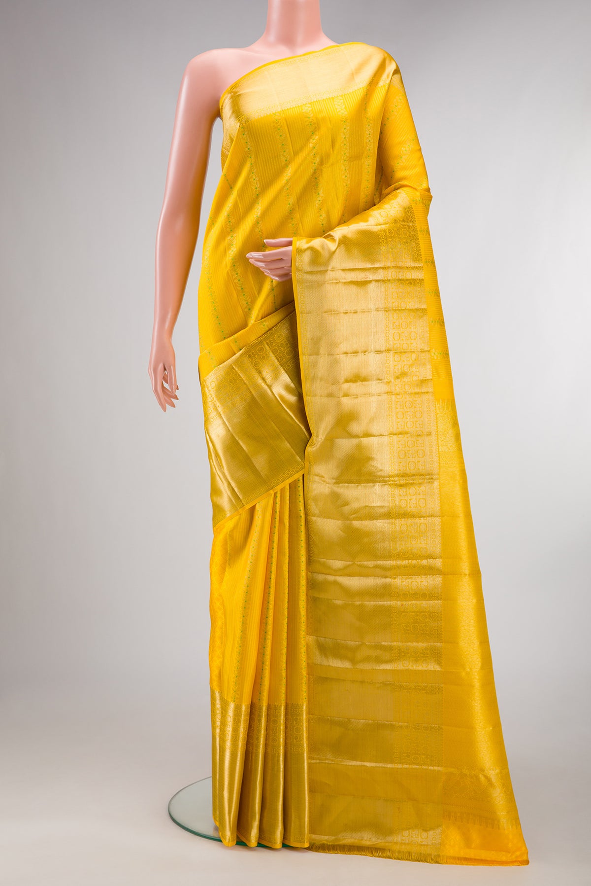 Pure Silk Yellow Kanjivaram Saree with Stripes on the body and Zari Border.  displayed on a mannequin
