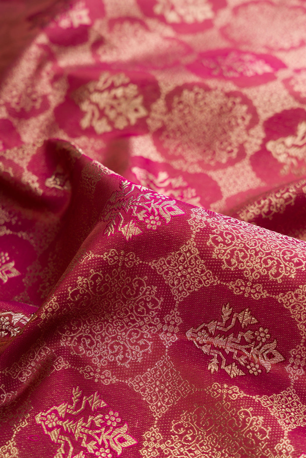 Close up of Maroon Kanjivaram Silk Saree with Zari Brocade on the body and Fancy Border.  displaying folds