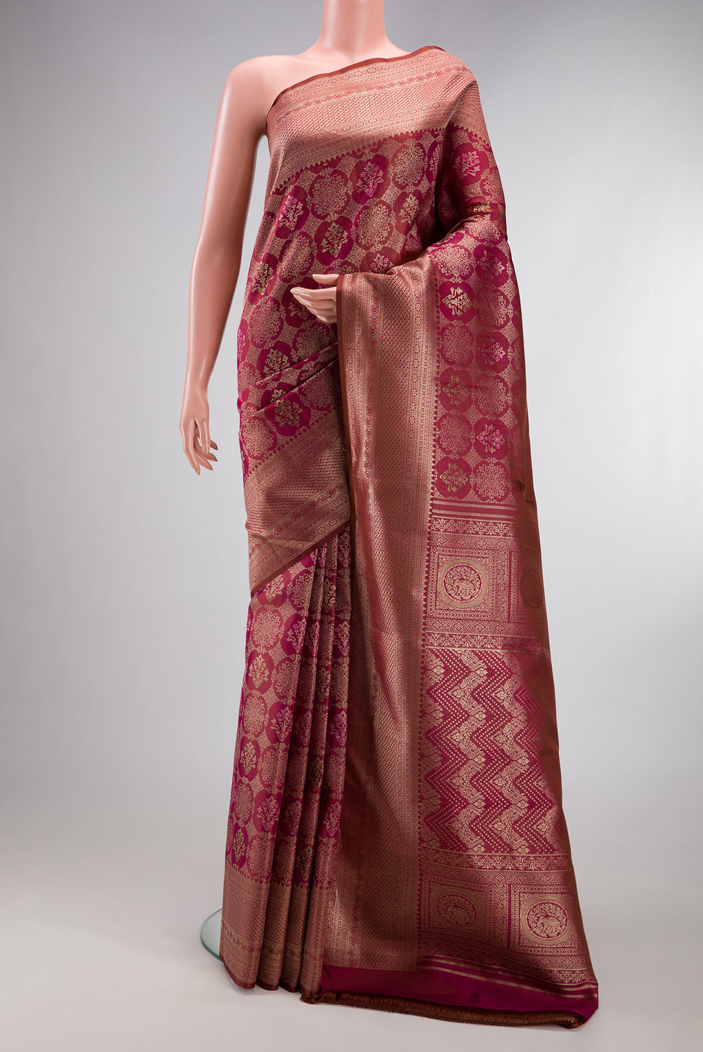 Maroon Kanjivaram Silk Saree with Zari Brocade on the body and Fancy Border.  displayed on a mannequin
