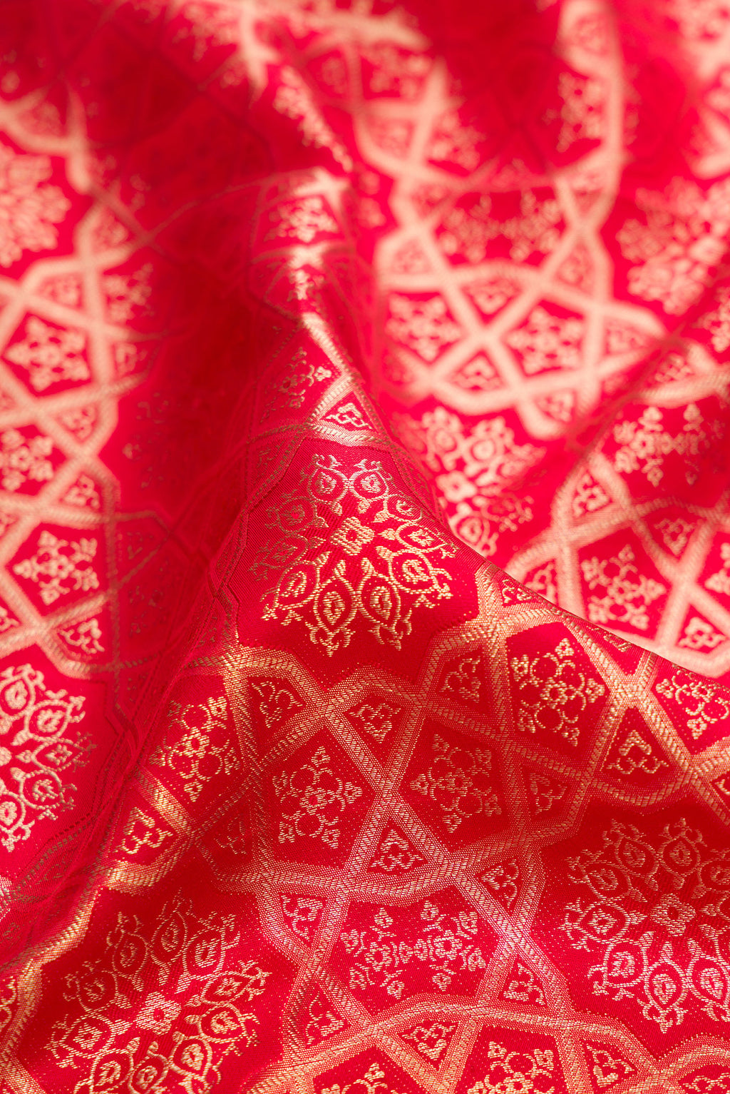 Close up of Pure Silk Red Kanjivaram Saree with Zari Brocade on the body and Fancy Border.  displaying folds
