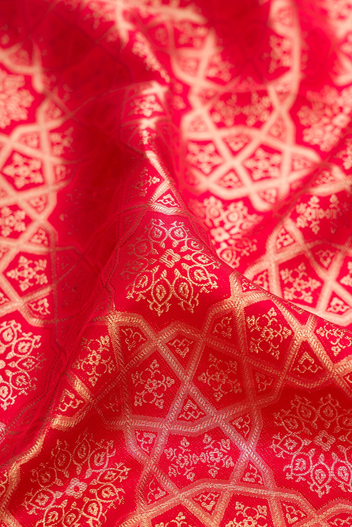 Close up of Pure Silk Red Kanjivaram Saree with Zari Brocade on the body and Fancy Border.  displaying folds