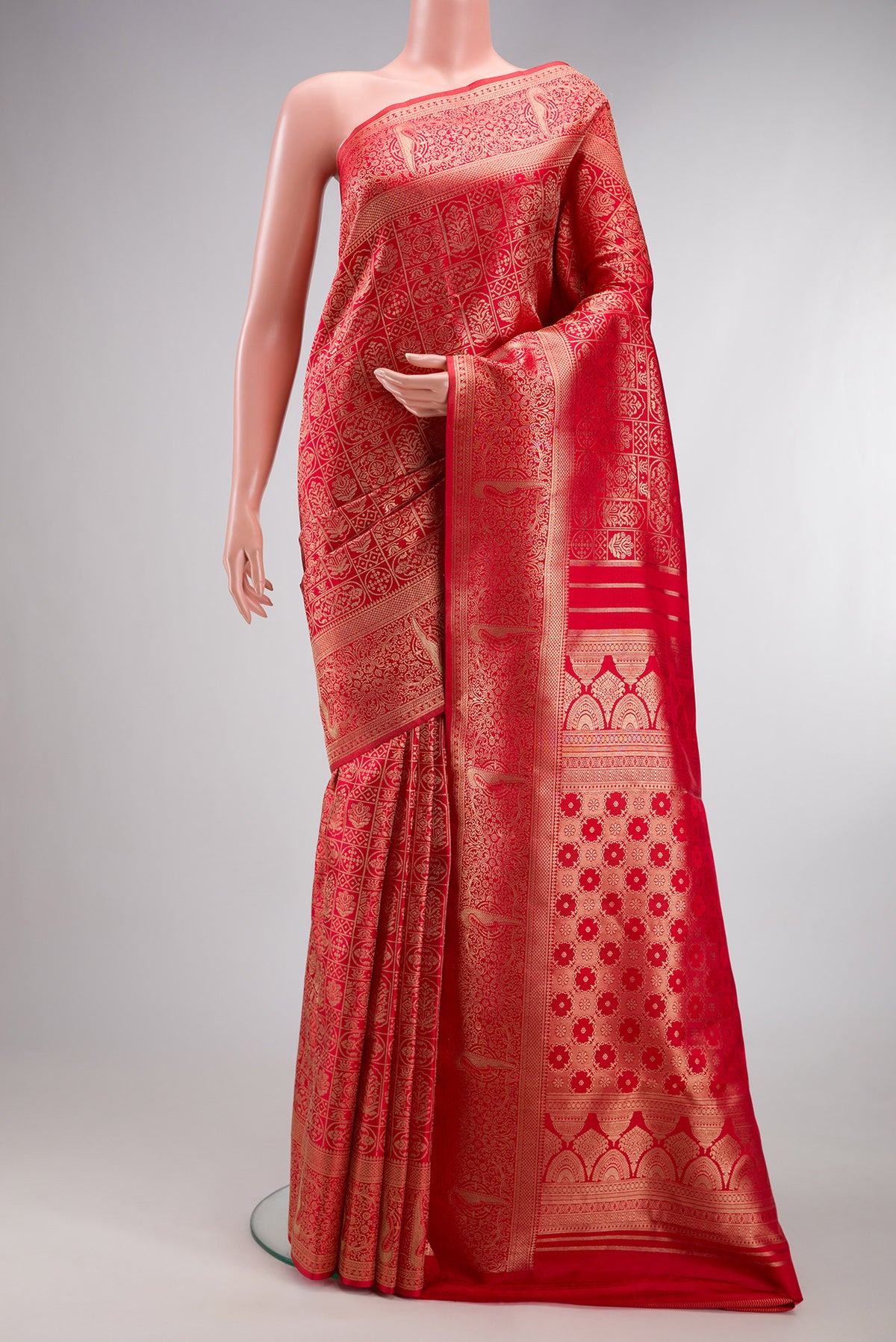 Red Kanjivaram Silk Saree with Zari Brocade on the body and Fancy Border.  displayed on a mannequin