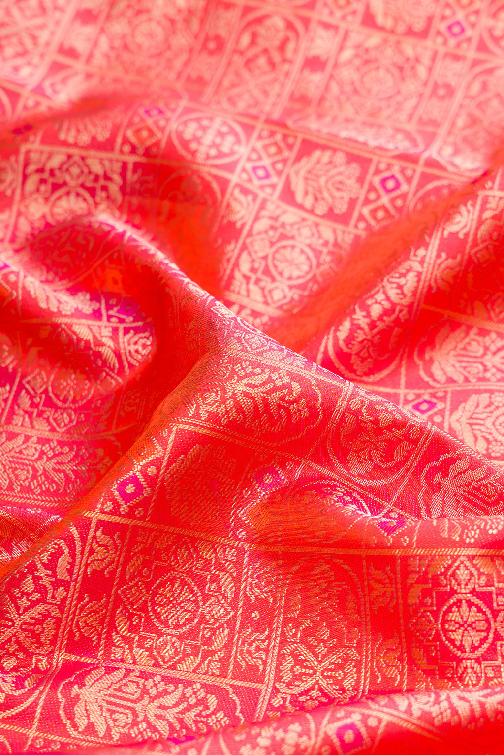 Close up of Orange Dual Tone Kanjivaram Silk Saree with Zari Brocade on the body and Fancy Border.  displaying folds