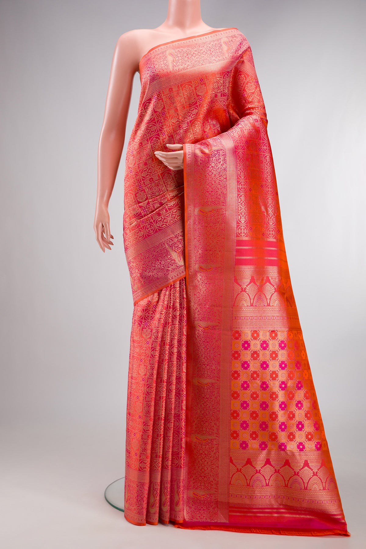 Orange Dual Tone Kanjivaram Silk Saree with Zari Brocade on the body and Fancy Border.  displayed on a mannequin