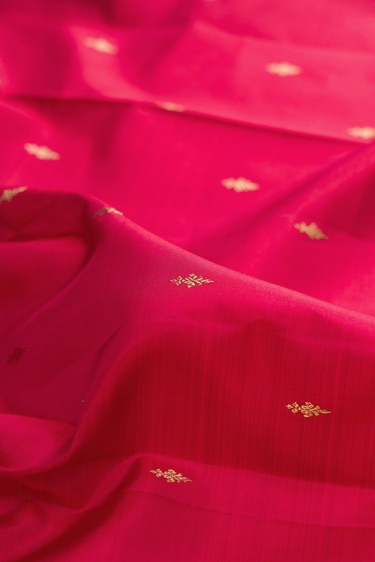 Close up of Pure Silk Deep Red Kanjivaram Saree with Zari Butta on the body and Fancy Border.  displaying folds