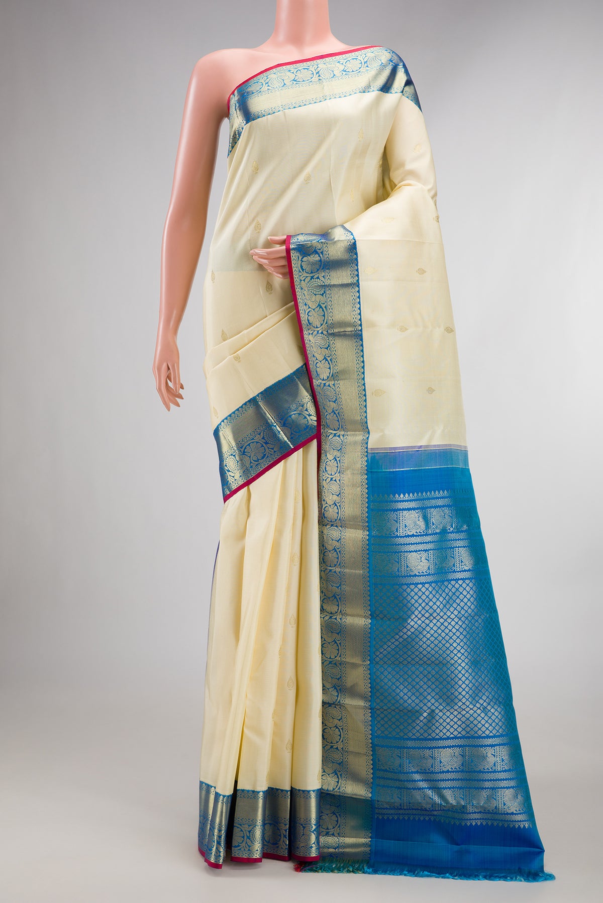 Pure Silk Off White Kanjivaram Saree with Zari Butta on the body and Zari Border.  displayed on a mannequin