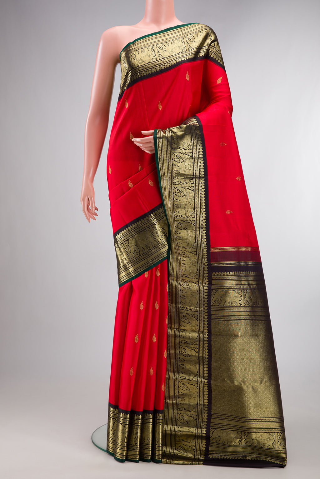 Pure Silk Red Kanjivaram Saree with Zari Butta on the body and Zari Border.  displayed on a mannequin