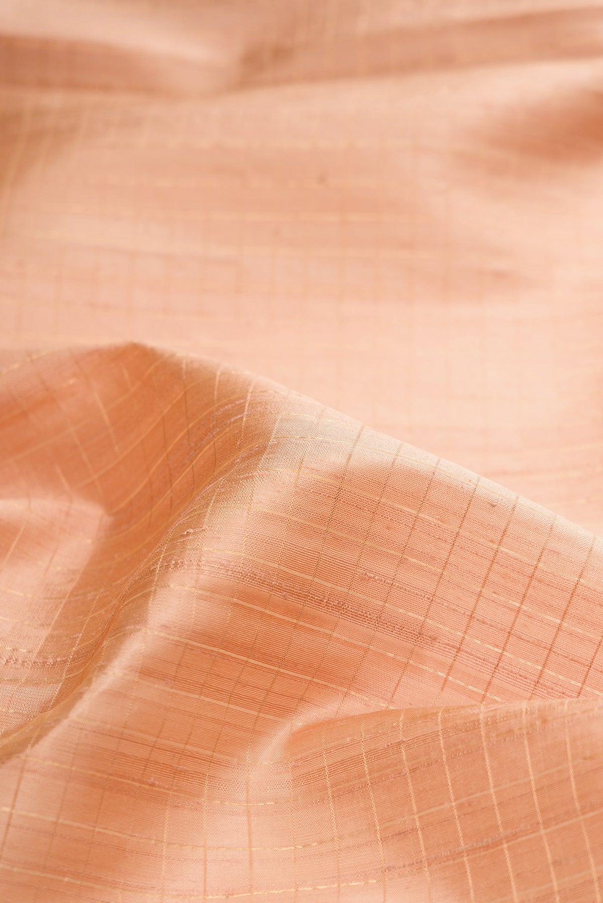 Close up of Pure Silk Sandal Raw Saree with Checked design on the body and Zari Border.  displaying folds