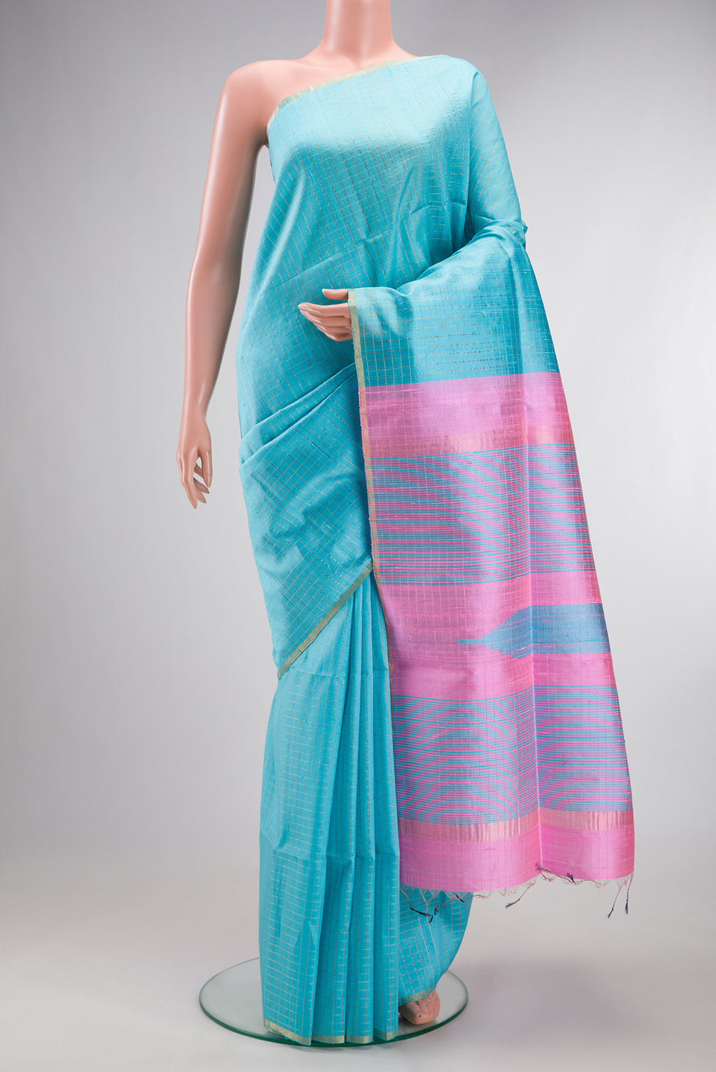 Pure Silk Sky Blue Raw Saree with Checked design on the body and Zari Border.  displayed on a mannequin