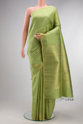 Pure Silk Pista Green Raw Saree with Zari Butta on the body and Zari Border.  displayed on a mannequin