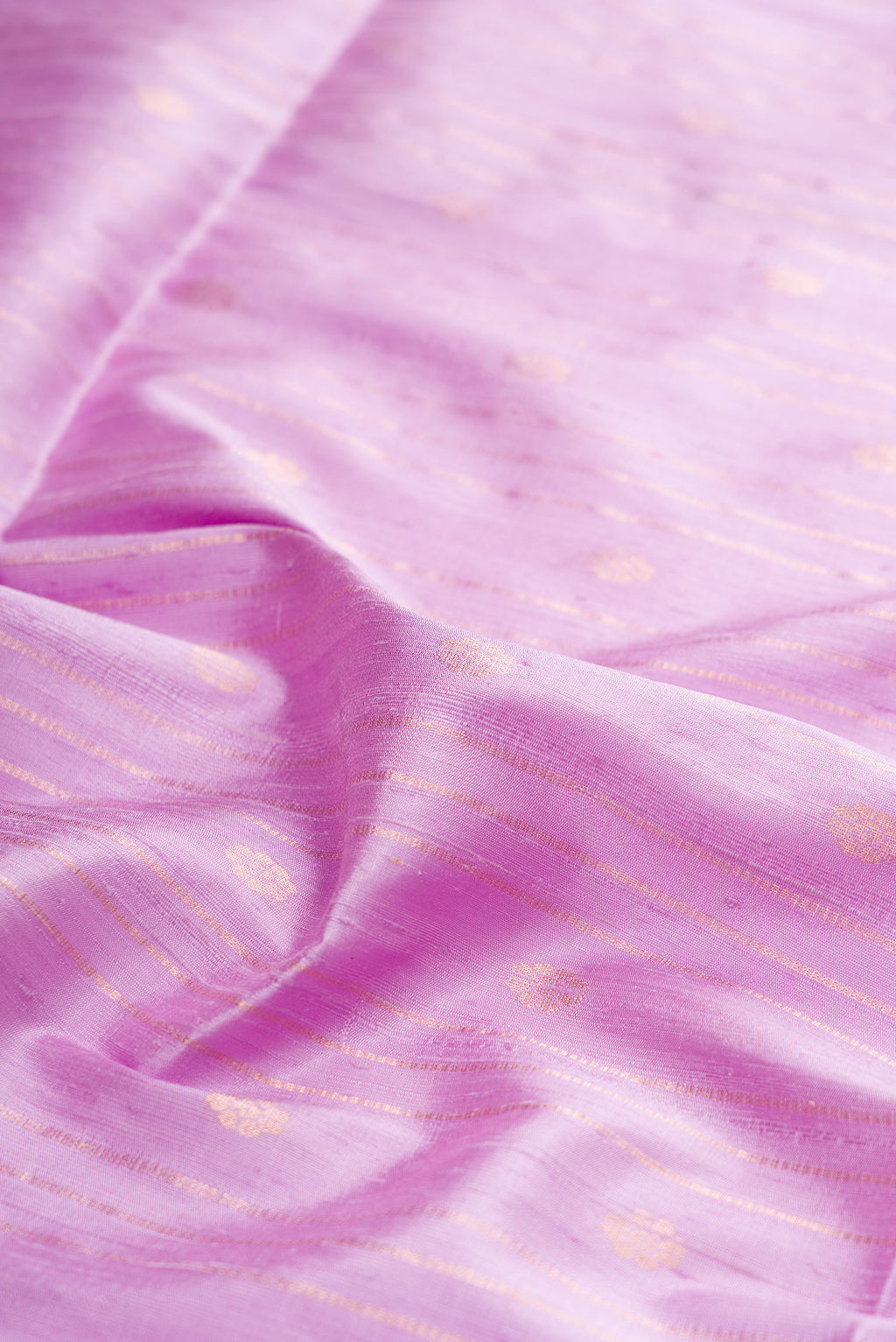 Close up of Pure Silk Lavender Raw Saree with Stripes on the body and Zari Border.  displaying folds