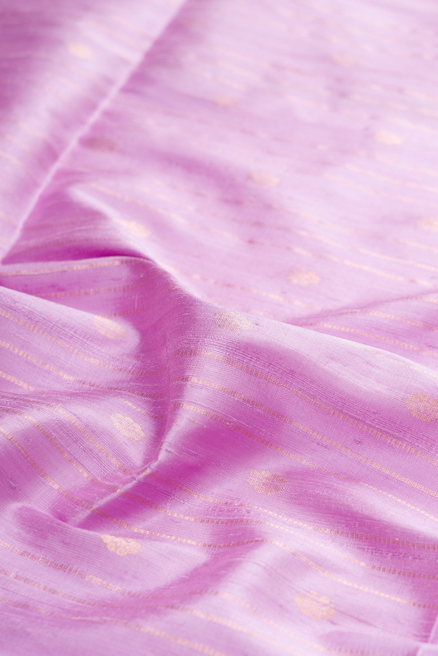 Close up of Pure Silk Lavender Raw Saree with Stripes on the body and Zari Border.  displaying folds