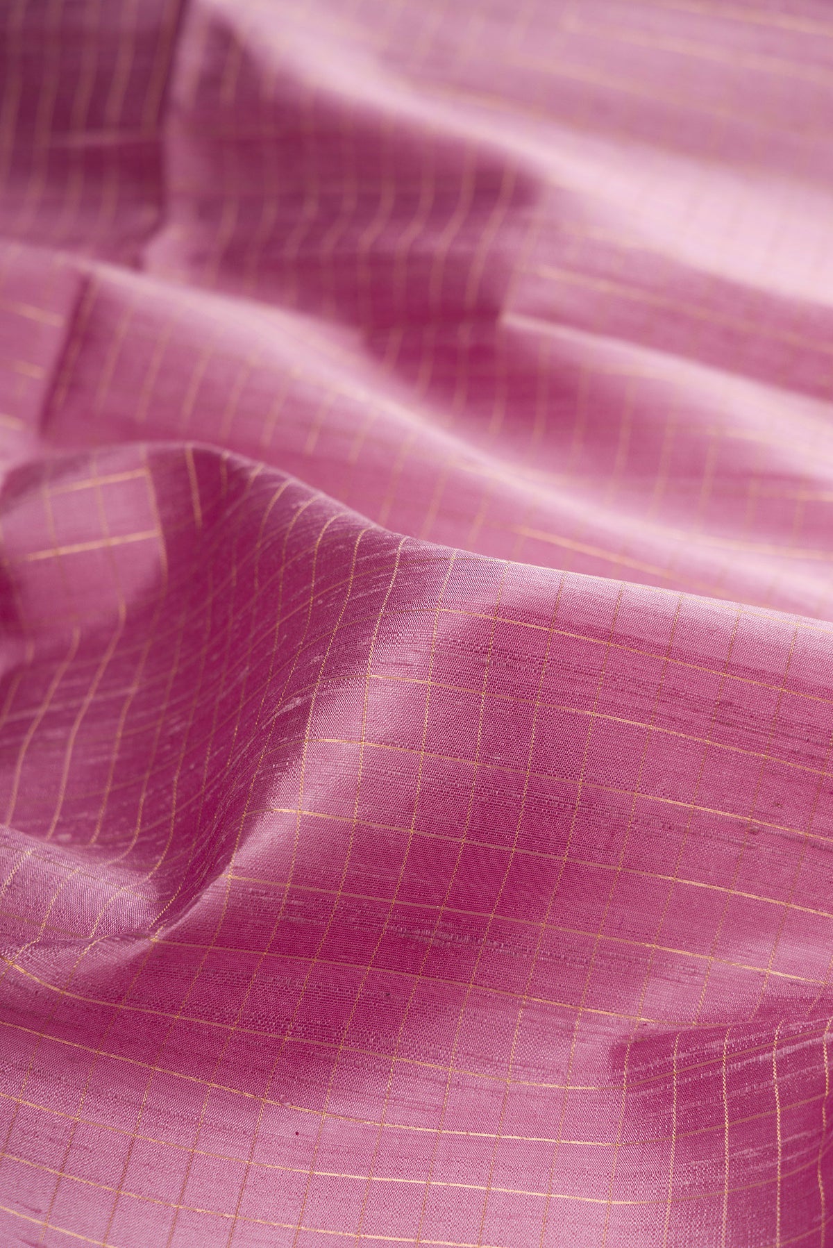 Close up of Pure Silk Lavender Raw Saree with Checked design on the body and Zari Border.  displaying folds