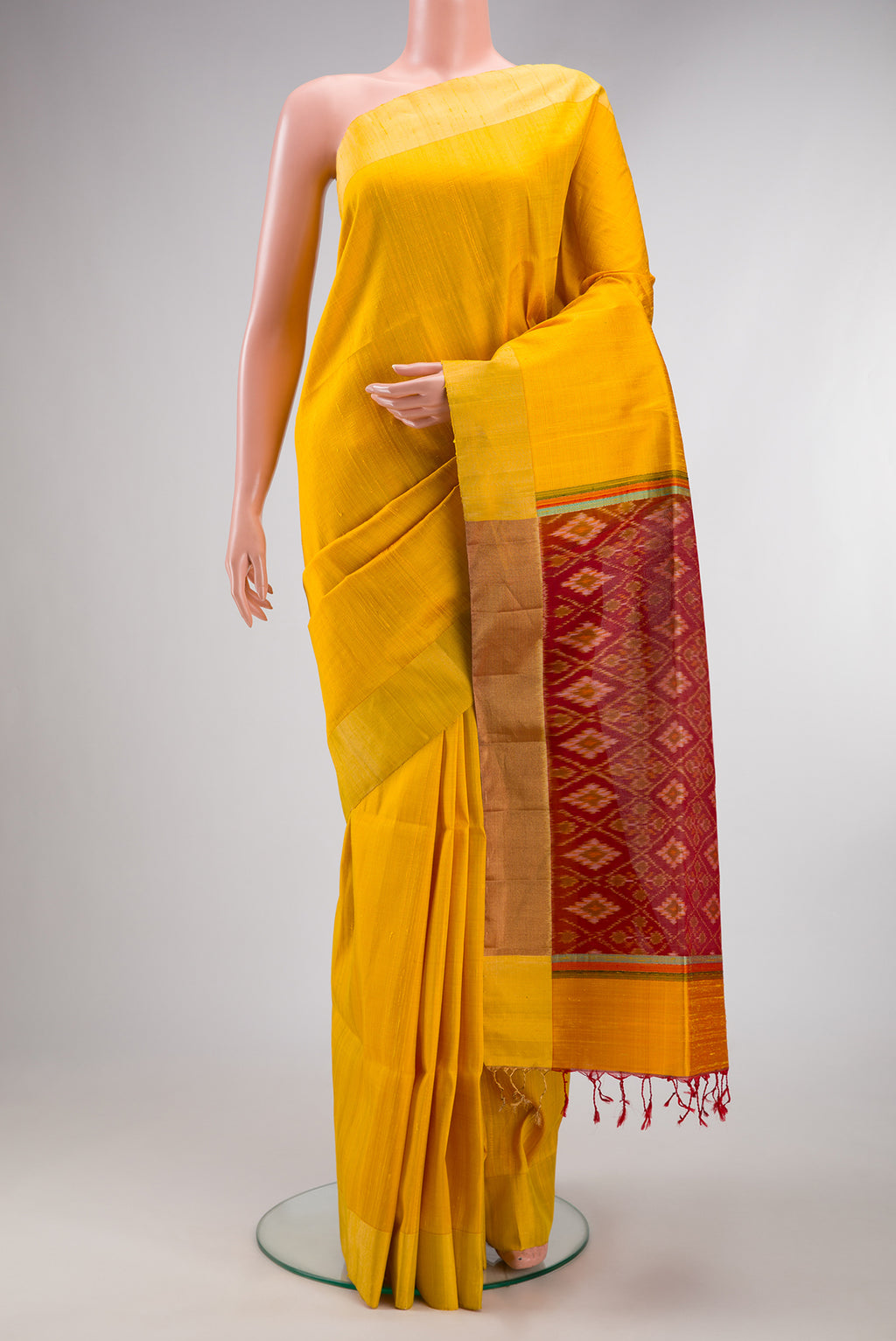 Pure Silk Yellow Raw Saree with Plain Body and Zari Border.  displayed on a mannequin