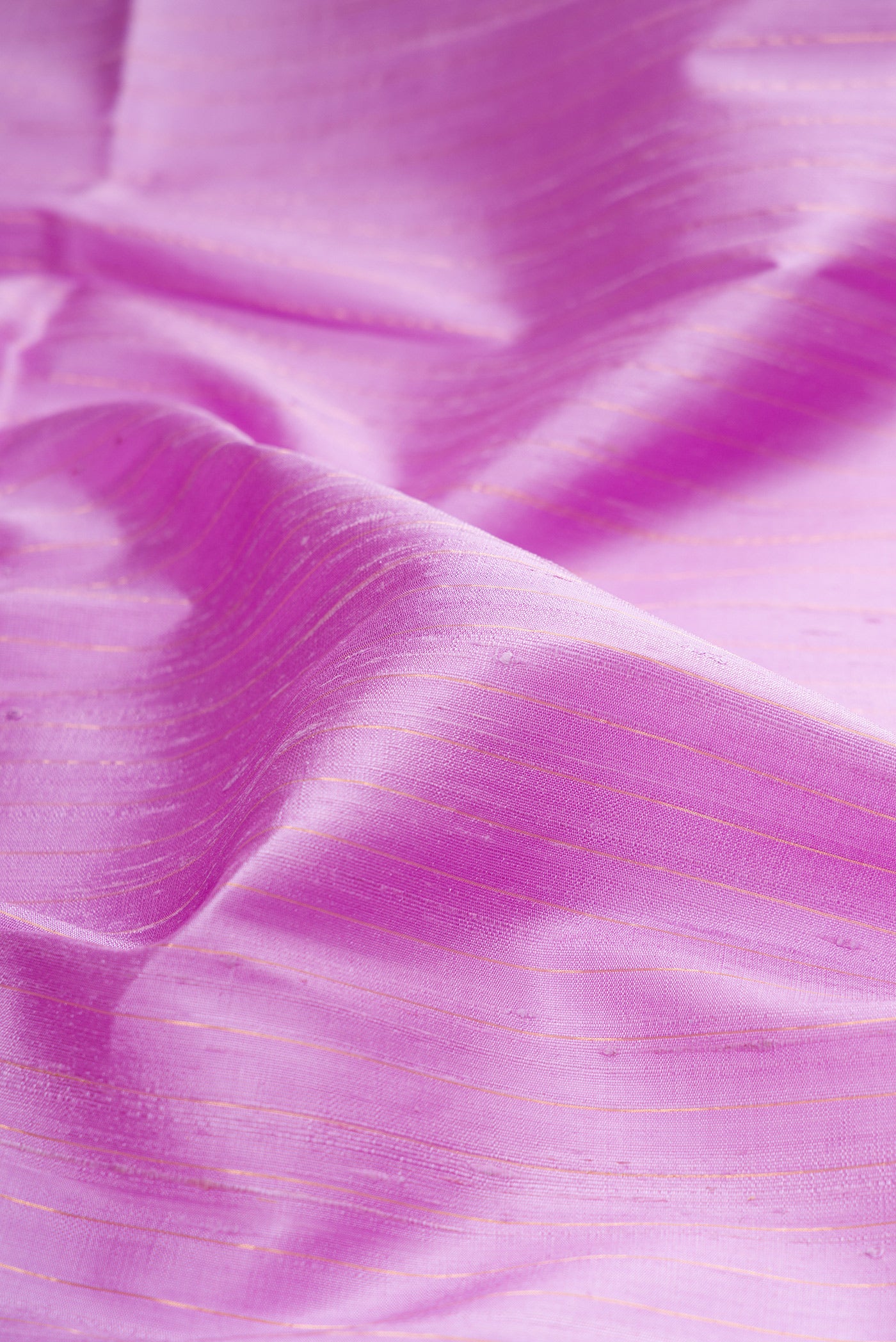 Close up of Pure Silk Lavender Raw Saree with Stripes on the body and Zari Border.  displaying folds