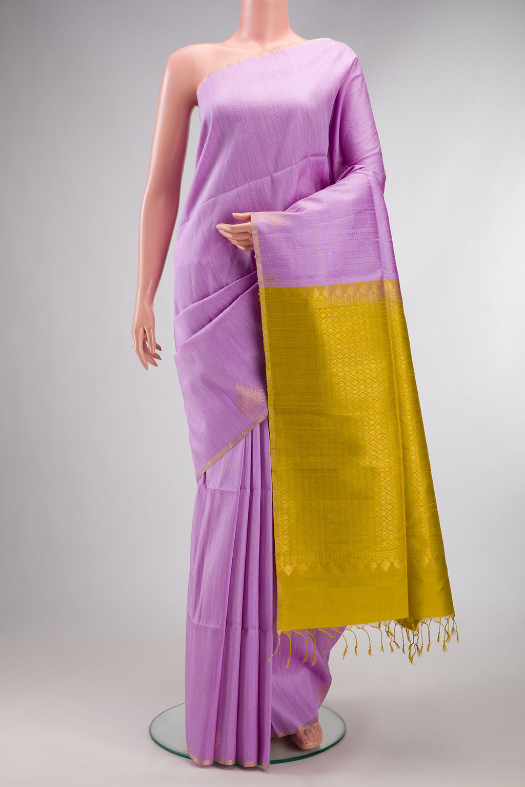 Pure Silk Lavender Raw Saree with Stripes on the body and Zari Border.  displayed on a mannequin