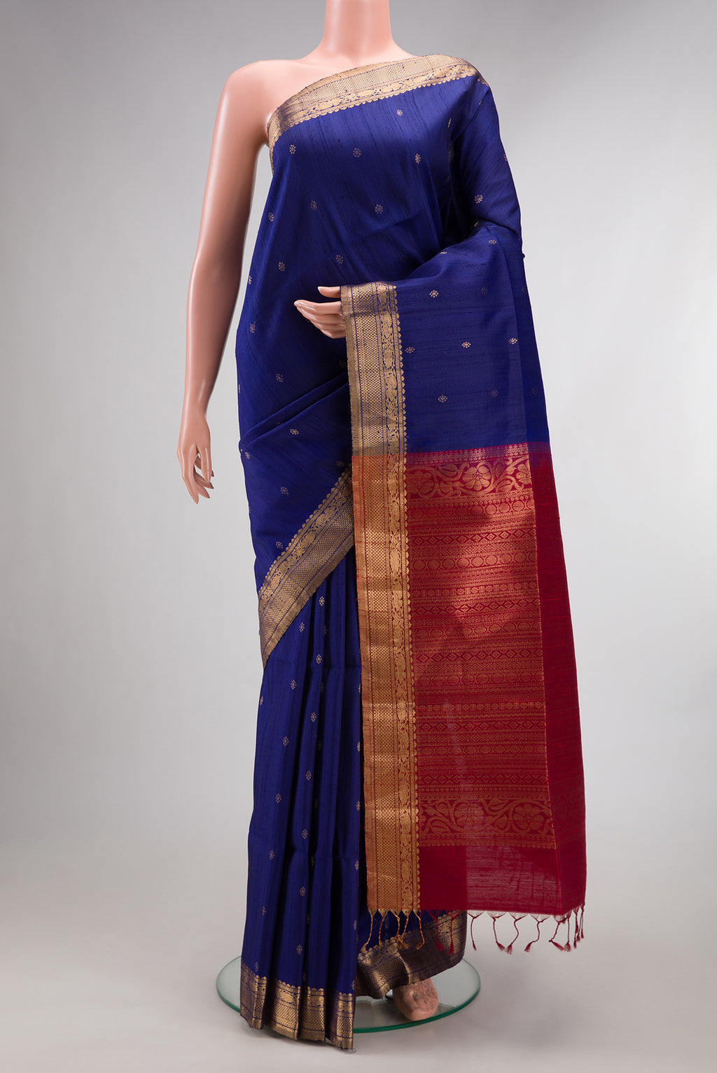 Dark Blue Raw Saree with Zari Butta on the body and Zari Border.  displayed on a mannequin