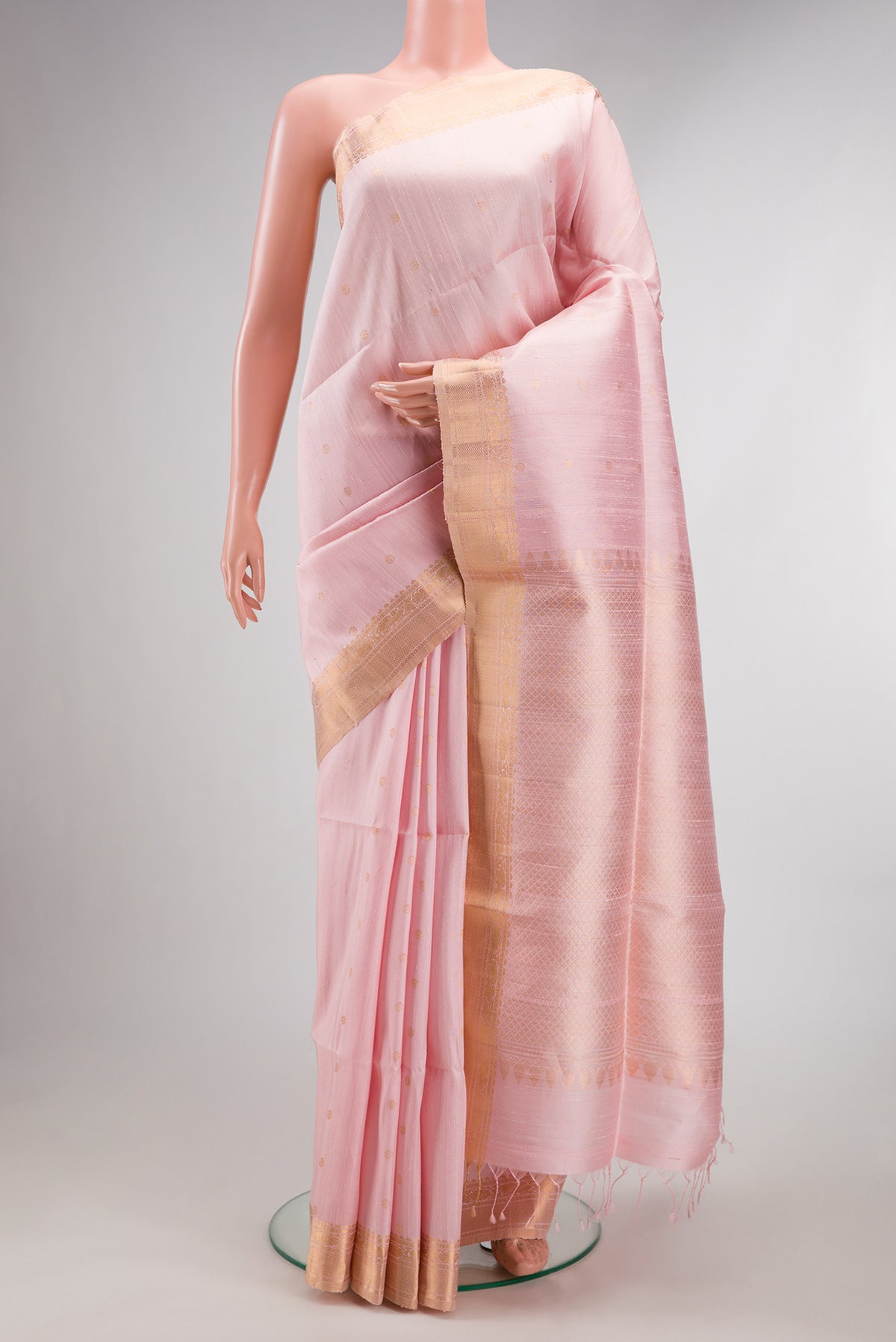 Rose pink Raw Saree with Zari Butta on the body and Zari Border.  displayed on a mannequin