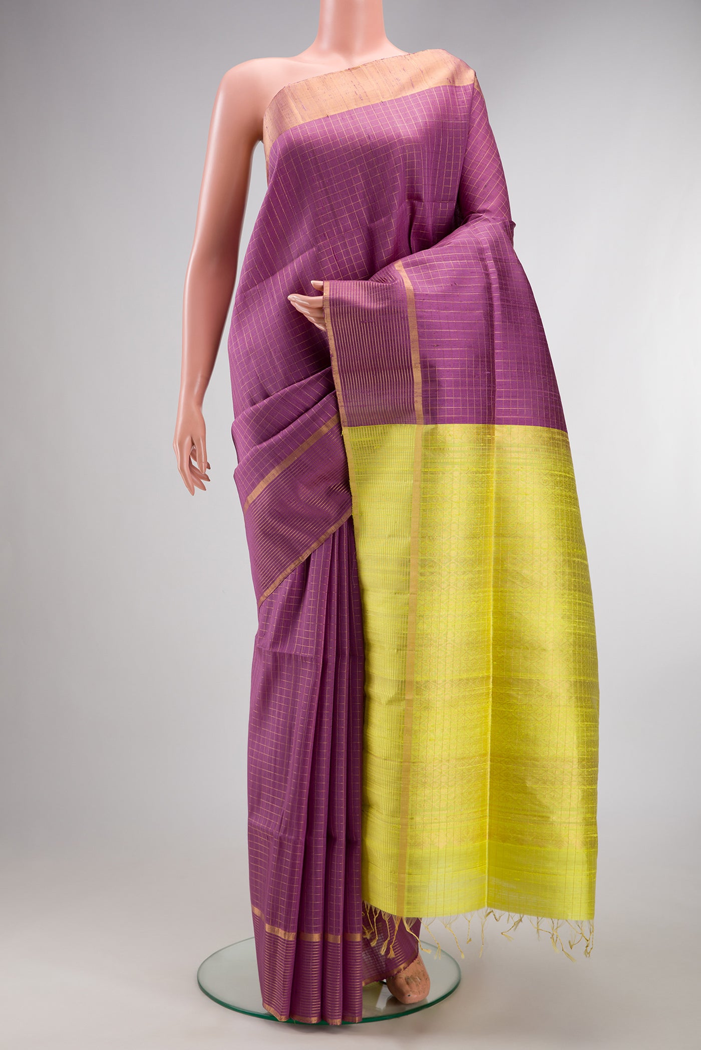 Pure Silk Purple Raw Saree with Checked design on the body and Fancy Border.  displayed on a mannequin