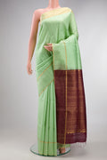 Pure Silk Pista Green Raw Saree with Checked design on the body and Fancy Border.  displayed on a mannequin