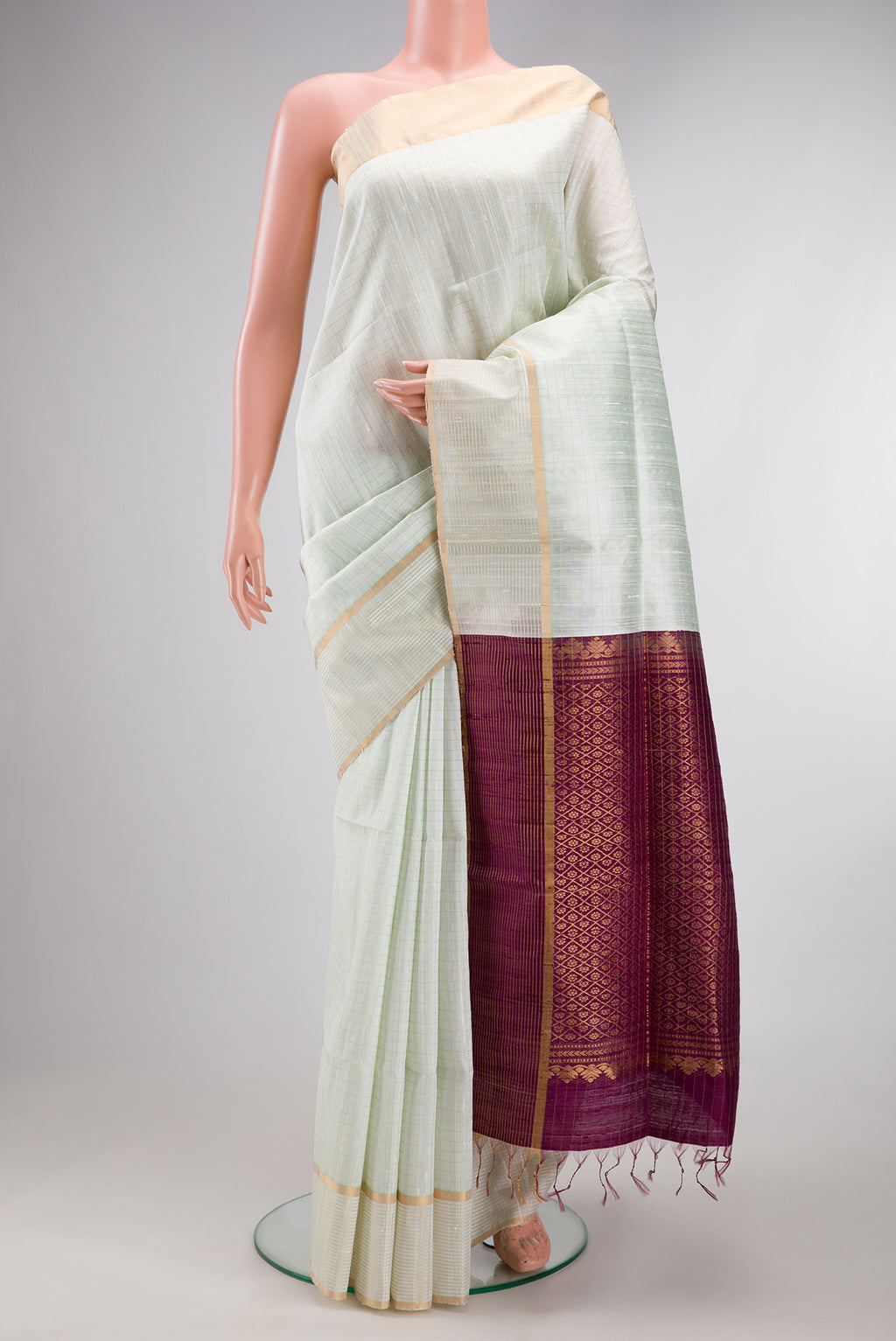 Pure Silk Off White Raw Saree with Checked design on the body and Zari Border.  displayed on a mannequin