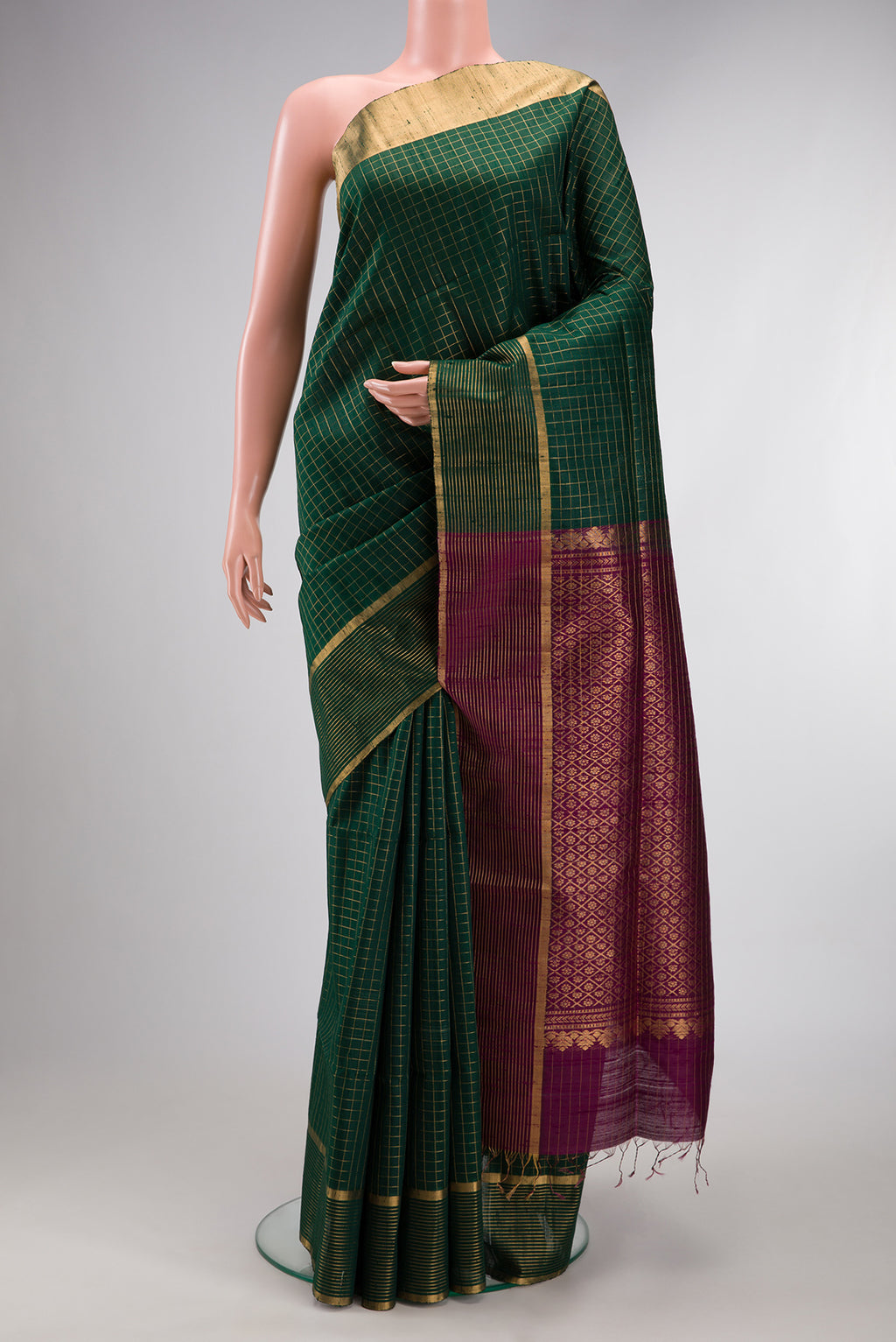 Pure Silk Bottle Green Raw Saree with Checked design on the body and Zari Border.  displayed on a mannequin